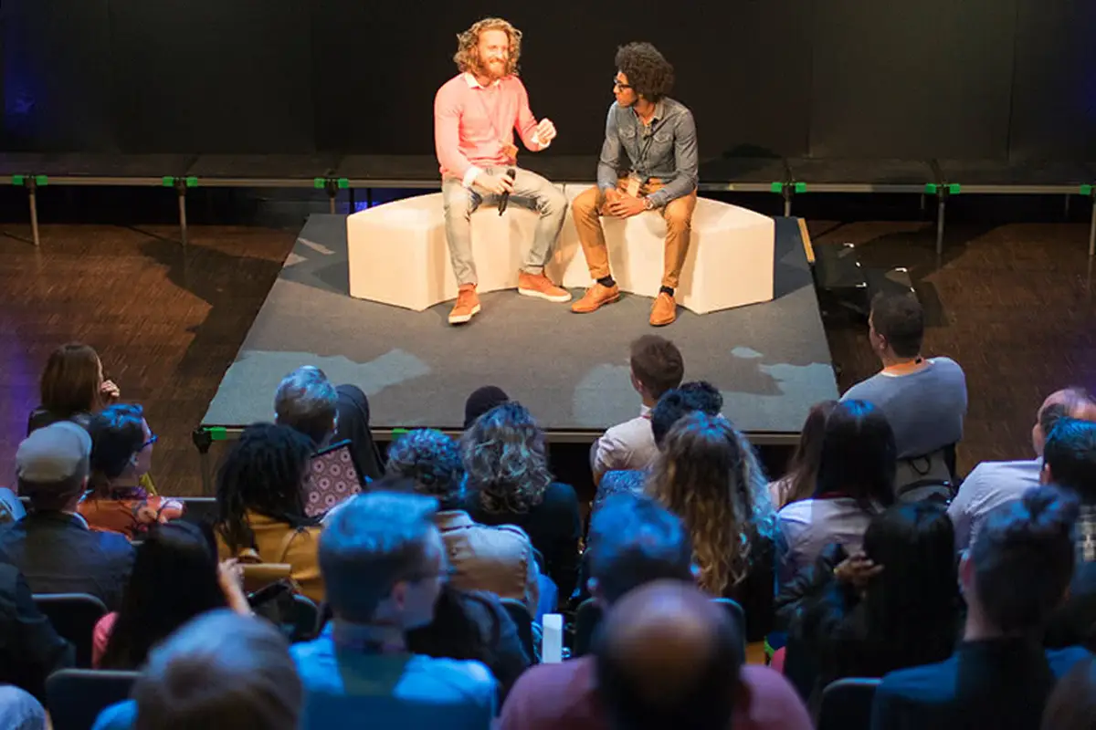 Two men giving a presentation in front of an audience.