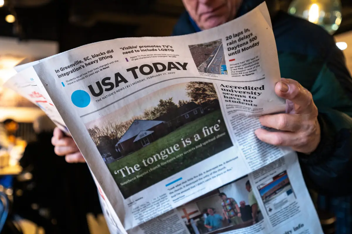 A man reading a newspaper.